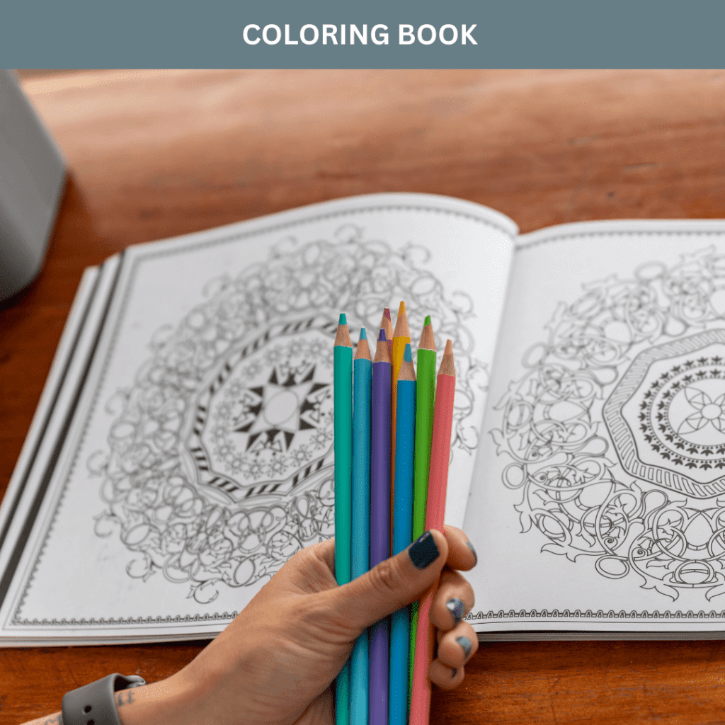 Hand holding a set of colored pencils over an adult coloring book with intricate patterns.