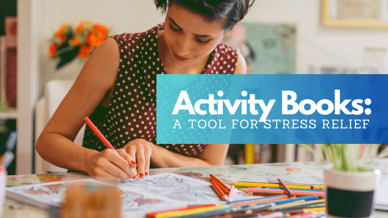 Woman engaging in stress relief activity by coloring in an activity book. Activity books for stress relief and mindfulness.